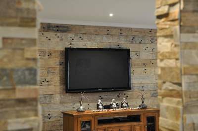Timber feature wall in living room by Northern Rivers Recycled Timber - Whitewashed Sleeper panels