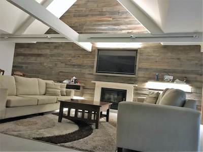 Timber feature wall in living room by Northern Rivers Recycled Timber - Brushed Pipeline panels