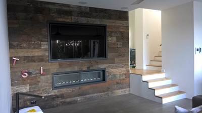 Timber feature wall in living room by Northern Rivers Recycled Timber - Weathered face Sleeper panels