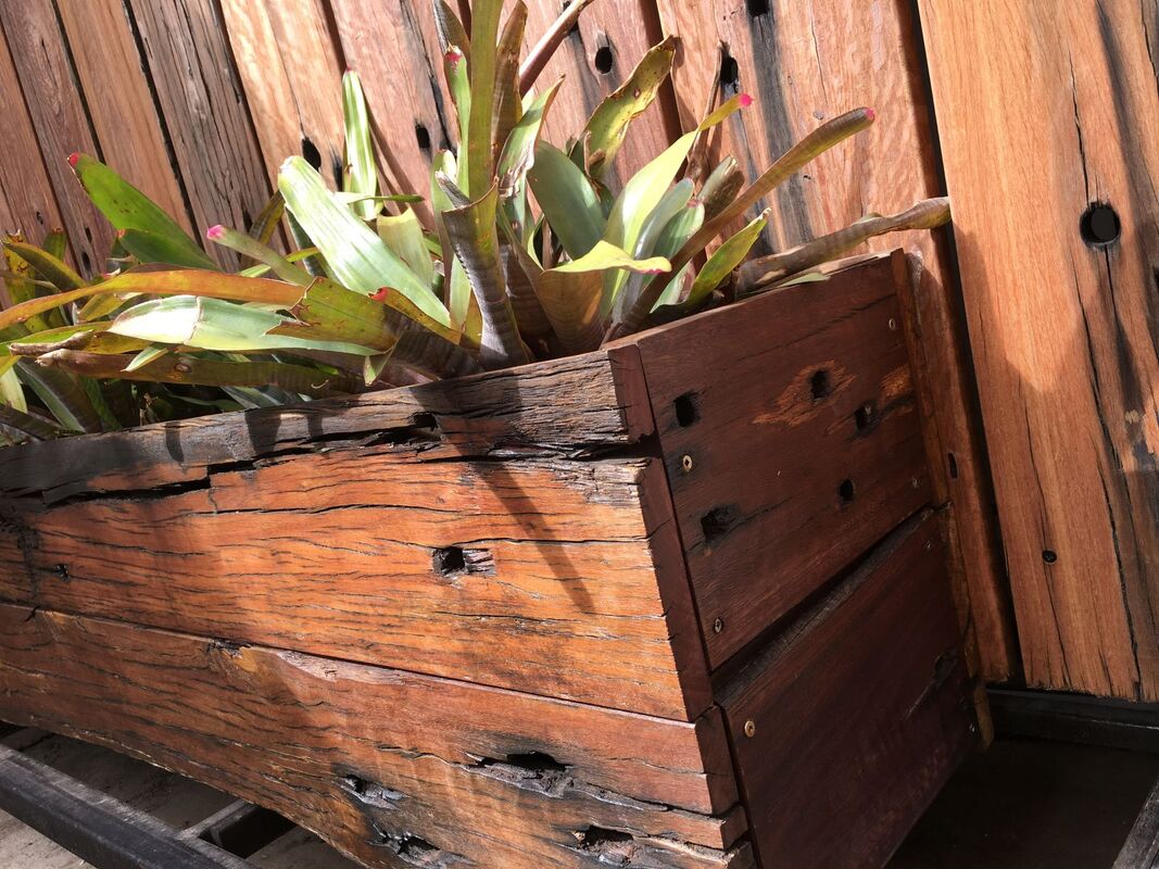 Railway sleeper planter box with high feature boards