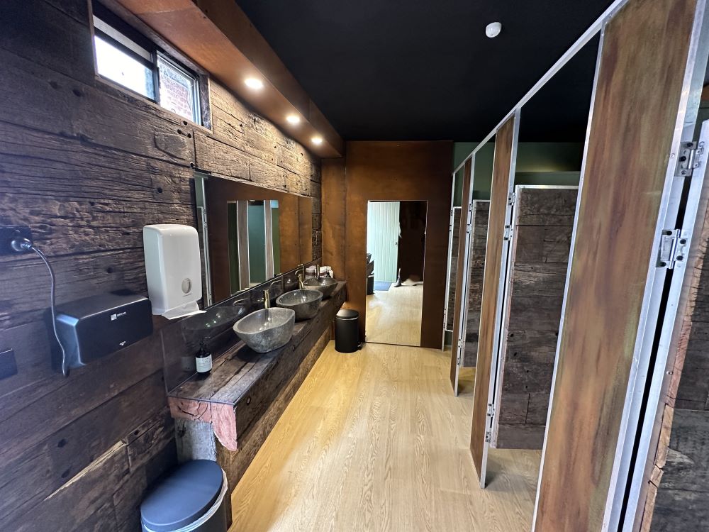 Rustic commercial bathroom with railway sleepers 