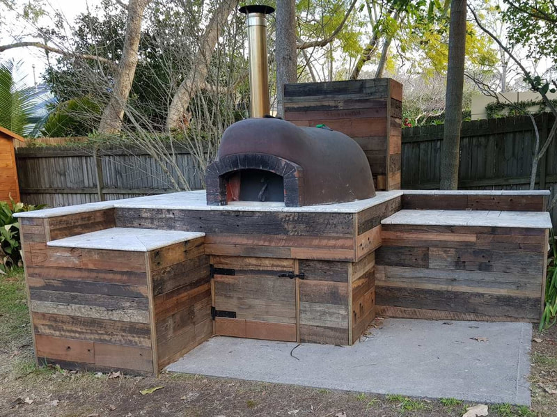 run of the mill recycled timber feature wall pizza oven