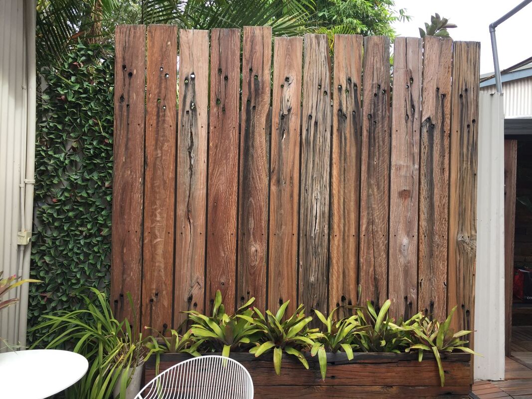 Railway sleeper fence with high feature boards